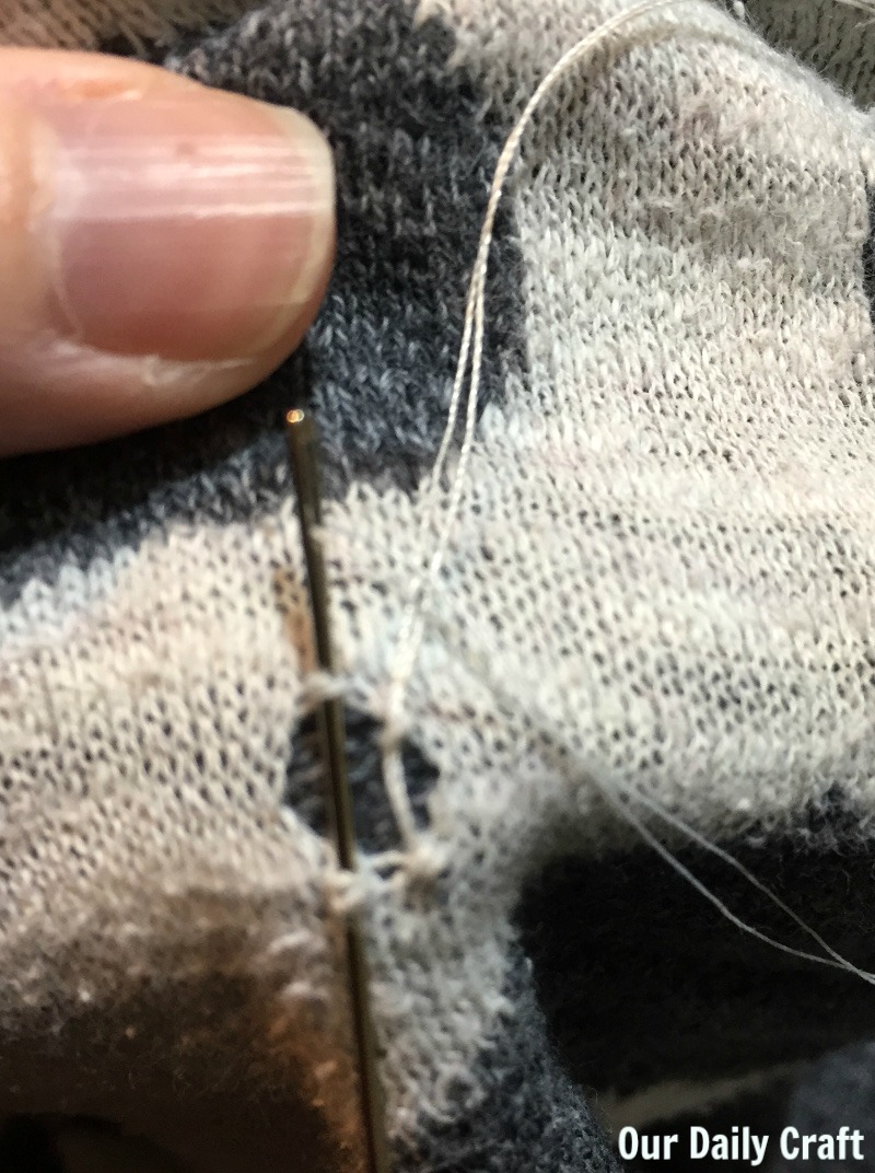 How to mend a hole in a sweater or another knit fabric garment.