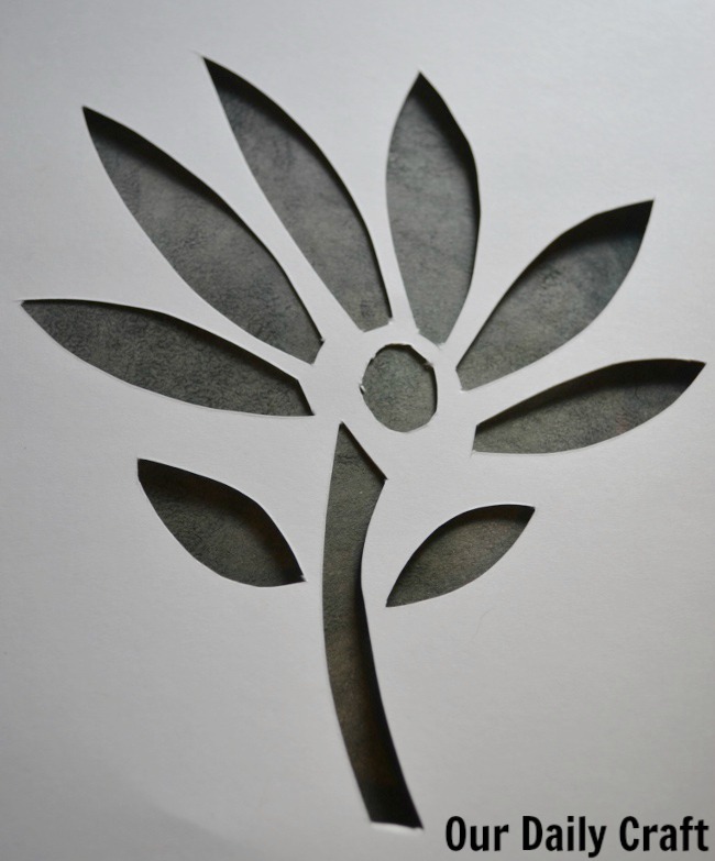 cut paper flower overlay on art