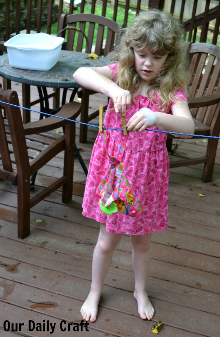 Washing doll clothes is a fun and easy activity for summer that gets kids into water.