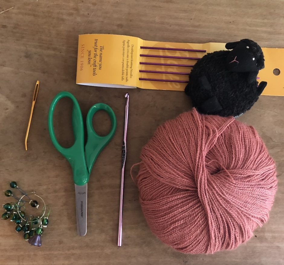 a selection of knitting tools for a travel knitting kit
